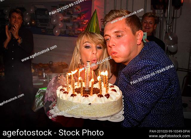 11 October 2020, Saxony-Anhalt, Dessau-Roßlau: The candles on Tim's birthday cake are blown out. Annemarie Eilfeld and her friend Tim Sandt celebrate the 30th...