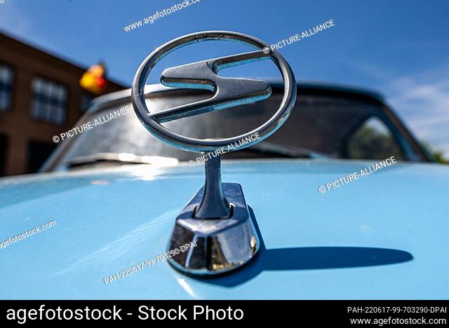 17 June 2022, Saxony, Zwickau: The Trabi emblem is attached to the hood of a Trabant 601. Trabi fans pitch their tents on the grounds of the former VEB...