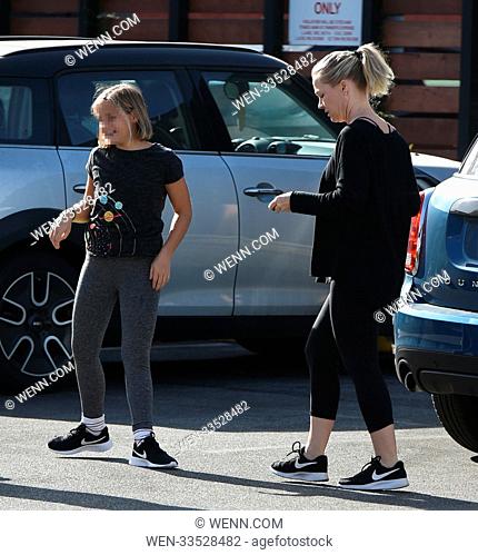 Jennie Garth does lunges with kettle bells with encouragement from her youngest daughter Fiona Eve Facinelli and a trainer Featuring: Jennie Garth