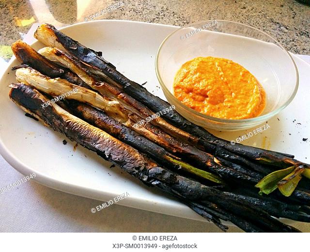 Calçots. Grilled onions. Typical recipe of Catalonia, Spain