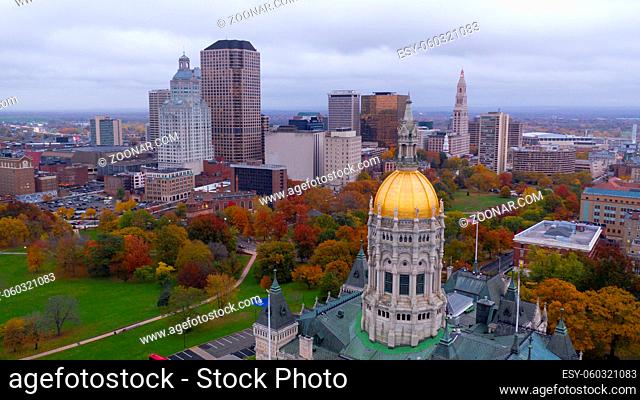 An aerial view focusing on the Connecticut State House with blazing fall color in the trees around Hartford