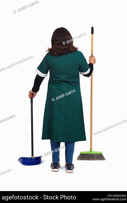 rear view of a portrait of a cleaning woman with broom and dustpan on white background