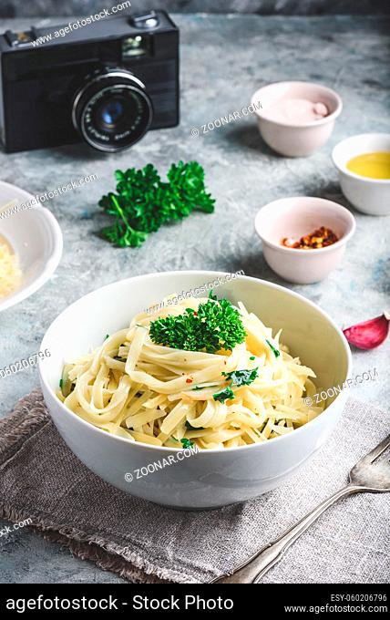 Easy lunch recipe. Linguine pasta with olive oil, garlic, fresh parsley and grated parmesan cheese