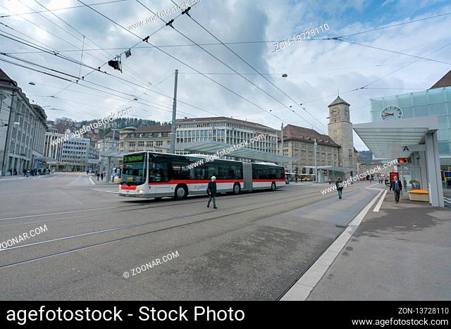 St. Gallen, SG / Switzerland - April 8, 2019: Sankt Gallen train station and local buses and commuter trains leaving the public transport hub with many people...
