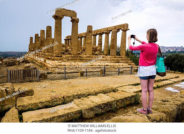 Tourist taking a photo at Temple of Juno, Valley of the Temples (Valle dei Templi), Agrigento, UNESCO World Heritage Site, Sicily, Italy, Europe