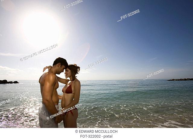 Young couple embracing in front of the sea
