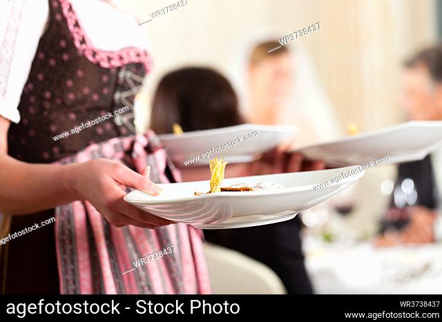 Wedding party at dinner - the dish is going to be served