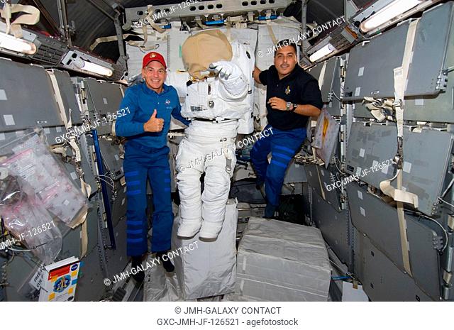 NASA astronauts Rick Sturckow (left) and Jose Hernandez, STS-128 commander and mission specialist, respectively, pose for a photo with an Extravehicular...
