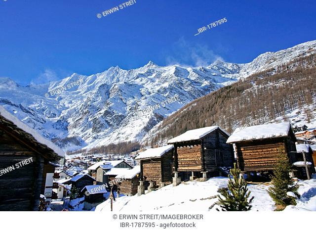Wintry view of Saas Fee and three four-thousand-metre high mountain peaks, Taeschhorn mountain, 4491 m, Dom mountain, 4545 m
