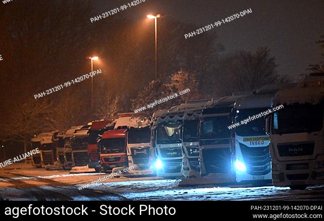 01 December 2023, Thuringia, Erfurt: Trucks parked side by side in a parking lot on the A4 highway. On December 1, the toll for heavy trucks on German highways...