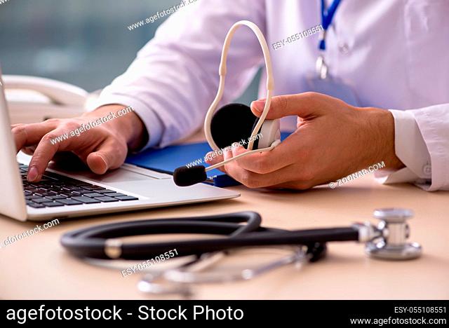 Young male doctor in telemedicine concept