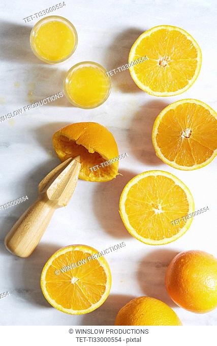 Sliced oranges with juicer