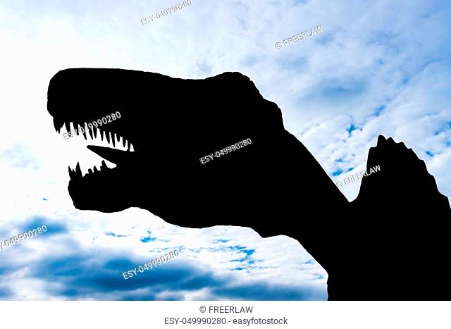 silhouette of a giant size Spinosaurus under blue sky