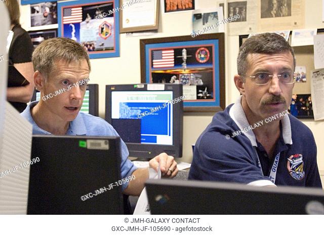 Astronauts Christopher J. Ferguson (left), STS-115 pilot, and Daniel C. Burbank, mission specialist, use the virtual reality lab at the Johnson Space Center to...
