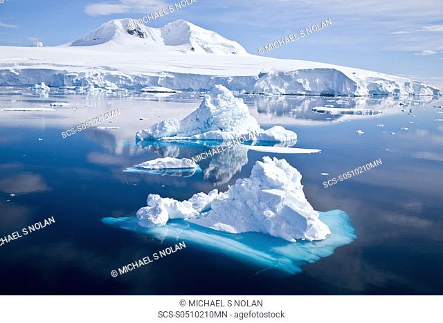 The Lindblad Expeditions ship National Geographic Explorer pushes through ice in Crystal Sound, south of the Antarctic Circle This area is full of flat first...