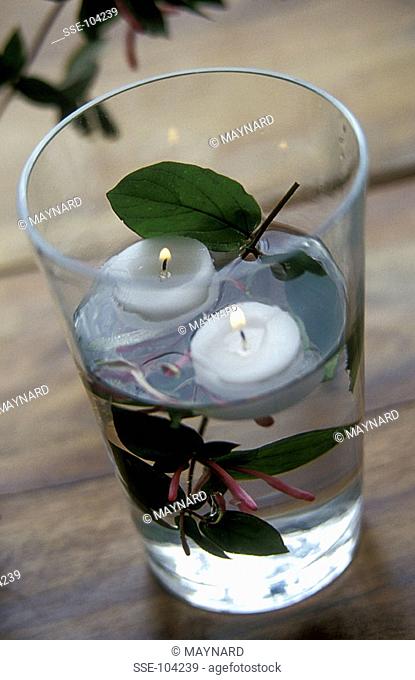 candles in glass of water