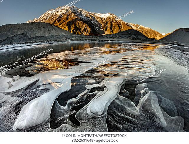 Mt Wakefield , ice bubbles and winter reflection in Mueller Lake, Aoraki / Mount Cook National Park, Canterbury, New Zealand