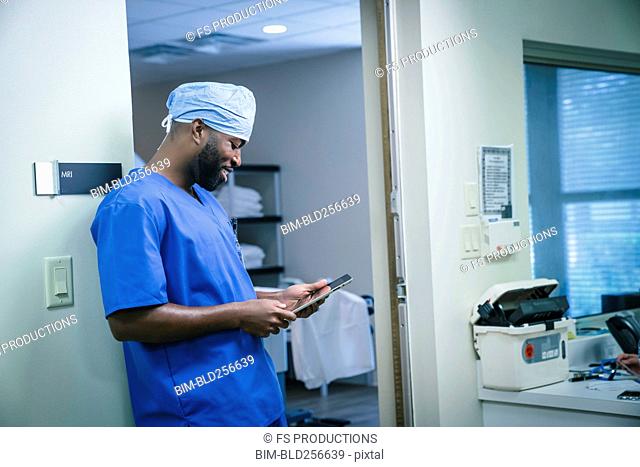 Enfermera negra sonriente con tableta digital