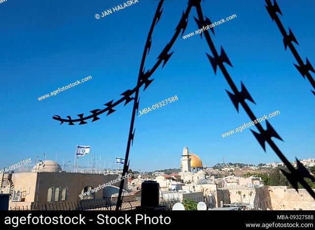 Israel - Jerusalem. Dome of the Rock and Western Wall viewed through a razor wire fence