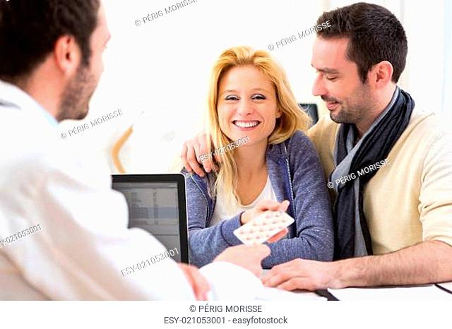Doctor gives pills to couple of patient