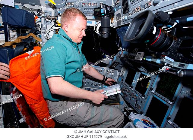 NASA astronaut Eric Boe, STS-133 pilot, occupies the commander's station on the flight deck of space shuttle Discovery during flight day two activities