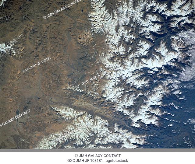 A section of the worlds most massive and tallest mountains, the Himalayas, are shown in this image that includes north central Nepal (left) and the south...