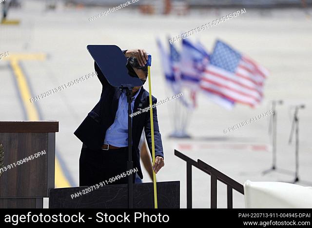 13 July 2022, Israel, Lod: White House staff check the podium at Ben Gurion airport ahead of the arrival of US President Joe Biden for the state visit to Israel