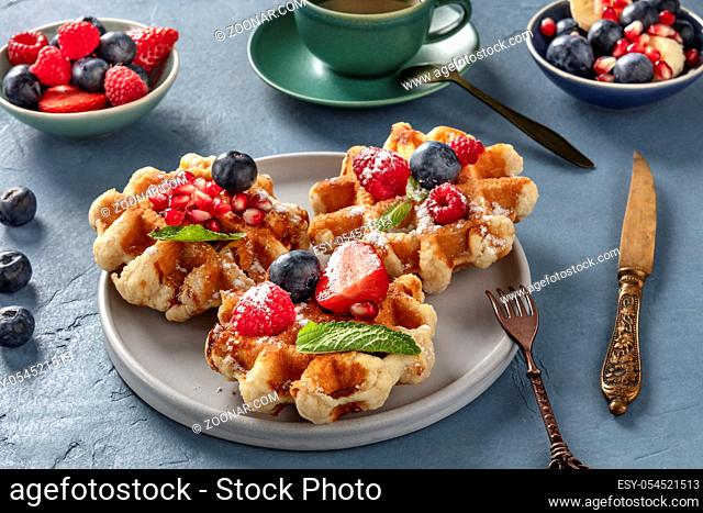 Belgian Waffles with fresh fruit and mint leaves, tasty breakfast