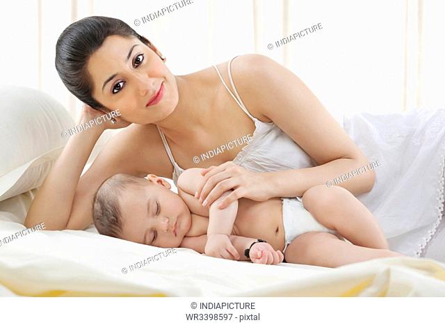 Portrait of a mother with her baby sleeping