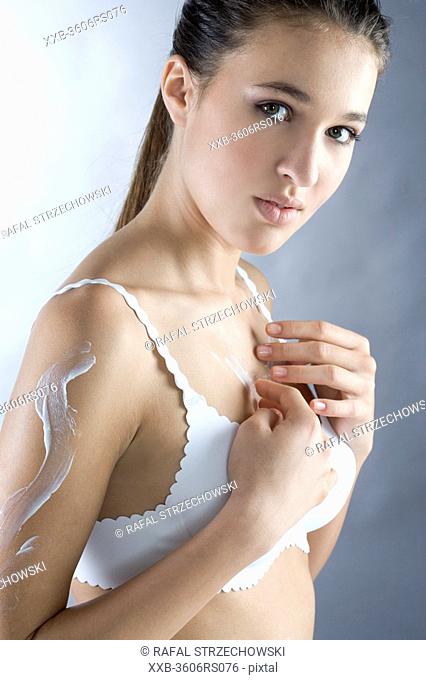 young woman creaming shoulder