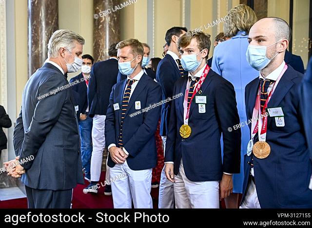 King Philippe - Filip of Belgium, Paralympic table tennis player Laurens Devos (2R) and Belgian cyclist Tim Celen (R) pictured during a royal reception for...