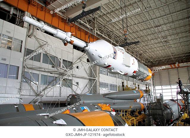 Russian specialists make final preparations on the Soyuz-FG launch vehicle and the Soyuz TMA-11 spacecraft scheduled to launch Oct