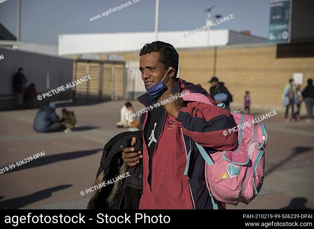18 February 2021, Mexico, Tijuana: A Central American migrant stands near the border crossing. Central American and Mexican migrants who are refugees at the...