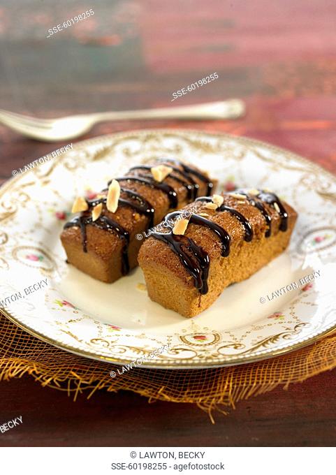 Mini almond cakes with melted chocolate topping