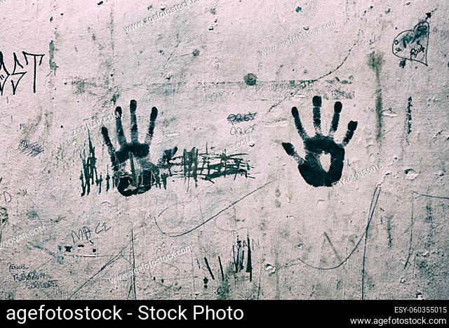 Right and Left black hand print marks on a ruined dirty white wall. Wallpaper
