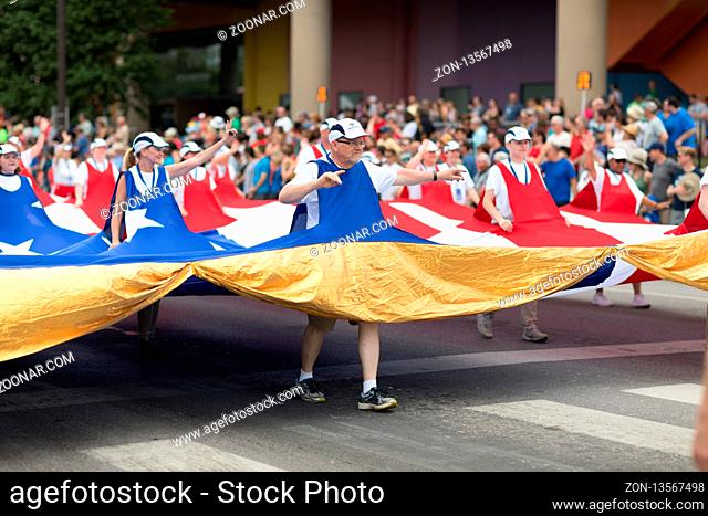 Indianapolis, Indiana, USA - May 26, 2018, People carrying a giant American flag through the streets at the Indy 500 Parade