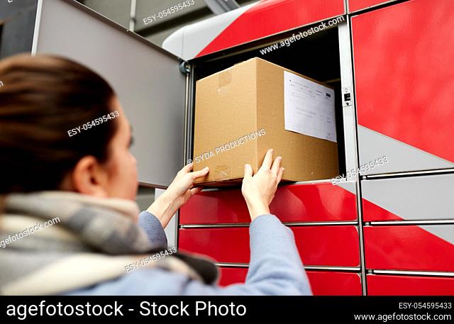 woman putting box to automated parcel machine