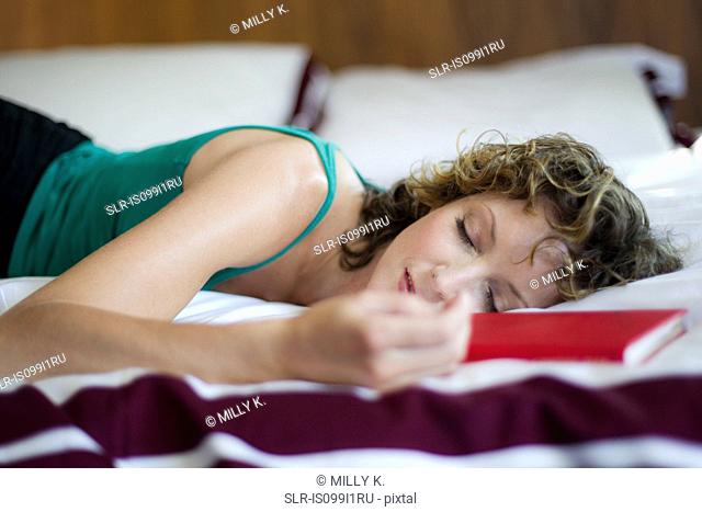 Mid adult woman sleeping in bedroom