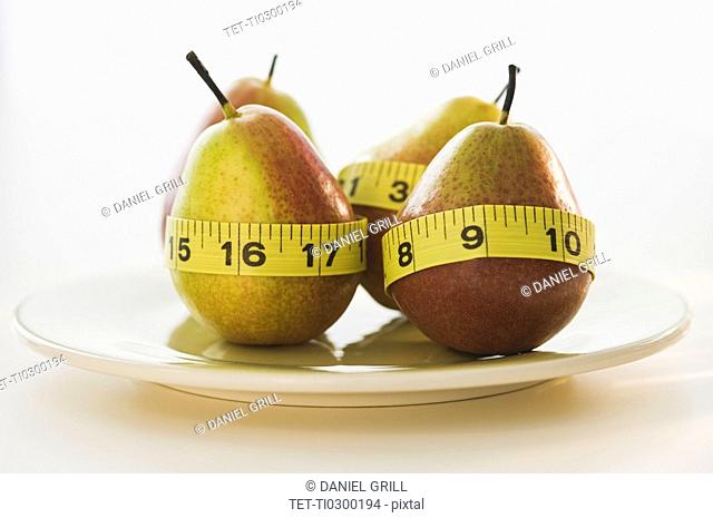 Pears wrapped in tape measures