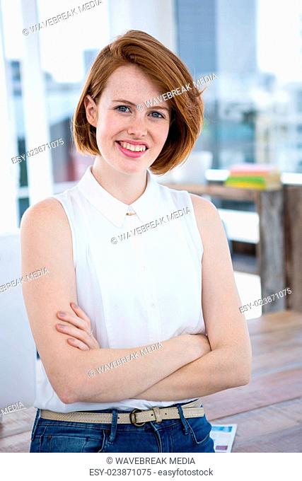 smiling hipster business woman with her arms crossed