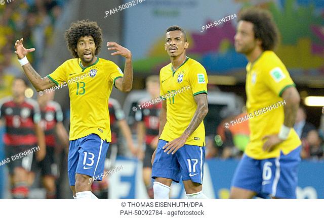 Brazil's Dante (L) and Luiz Gustavo gesture during the FIFA World Cup 2014 semi-final soccer match between Brazil and Germany at Estadio Mineirao in Belo...
