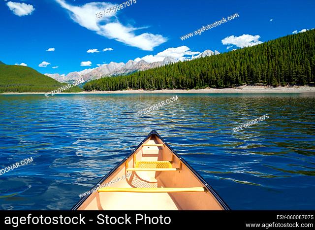 A single canoe on a mountain lake in the Canadian Rocky Mountains