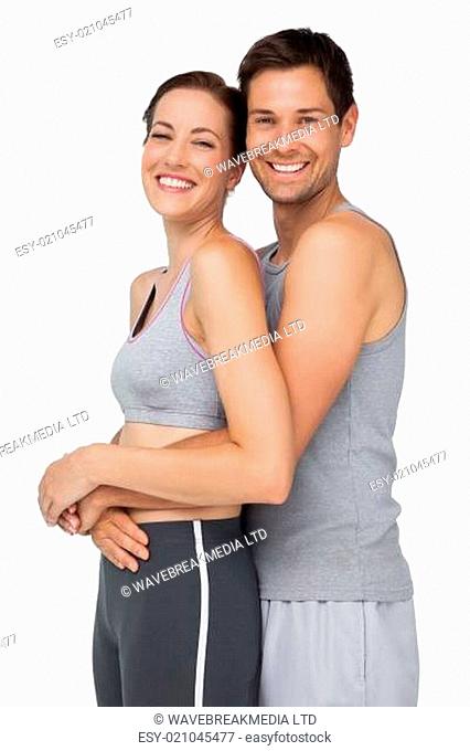 Side portrait of a happy fit young couple