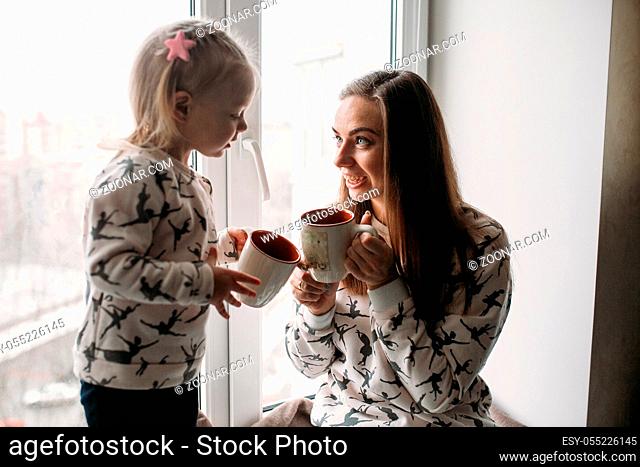Happy loving family. Young mother and her daughter girl play in kids room