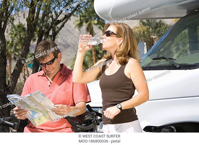 Mature couple on cycling holiday with recreational vehicle