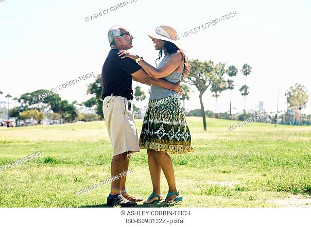 Senior couple dancing outdoors, Long Beach, California, USA