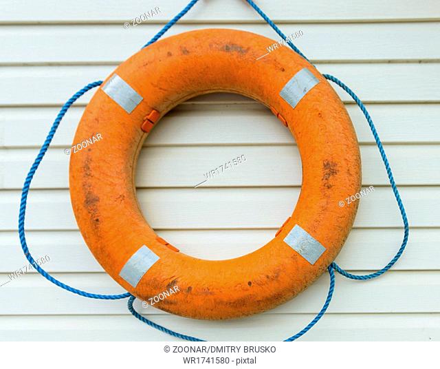 life buoy with rope hanging around the pool