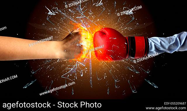 Two hands fighting and breaking a glass into small pieces