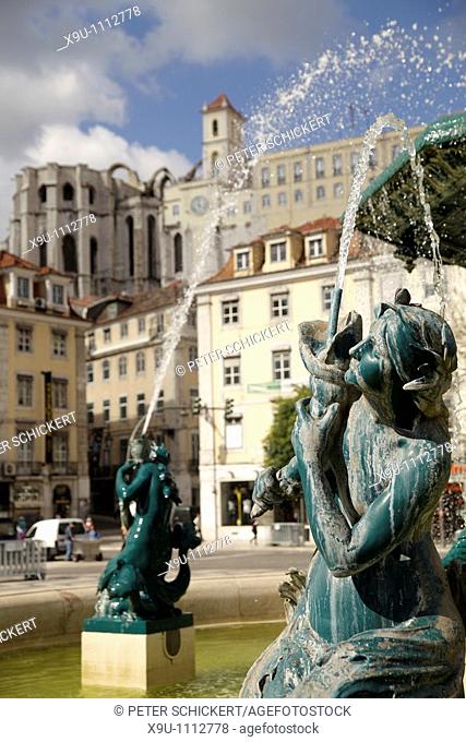 fountain on the square Praca de Dom Pedro IV or Rossio and the ruin of the church Igreja do Carmo in Lisbon, Portugal, Europe