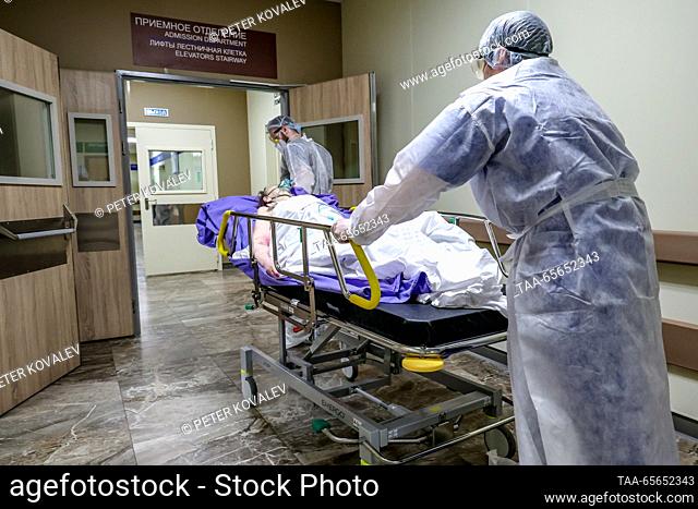 RUSSIA, ST PETERSBURG - DECEMBER 11, 2023: Medical workers move a COVID-19 ward patient on a gurney at St George City Hospital